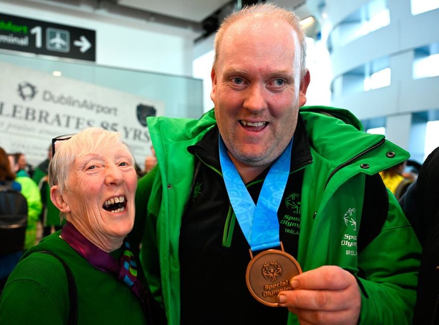 16 March 2025; Floorball Bronze Medal winner Niall Corcoran of Team Ireland, a member of Waterford Special Olympics Club, Ballinahassig, Cork, is greeted by his mother Dympna on his arrival at Dublin airport after competing in the Turin 2025 Special Olympics World Winter Games in Italy. Photo by Ray McManus/Sportsfile 