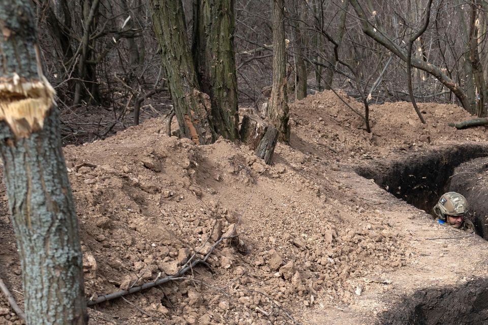 Ukrainian servicemen take their position in a trench at the front line, near Bakhmut, Donetsk region (Efrem Lukatsky/AP)