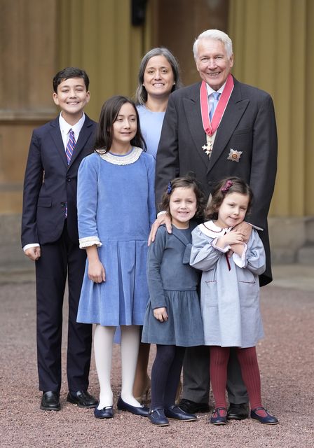 Professor Sir Philip Bobbitt with family members after being made a Knight Commander of the British Empire (Andrew Matthews/PA)