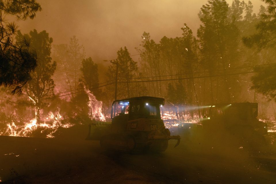 Firefighting bulldozers in the community of Cohasset near Chico (Stephen Lam/San Francisco Chronicle/AP)