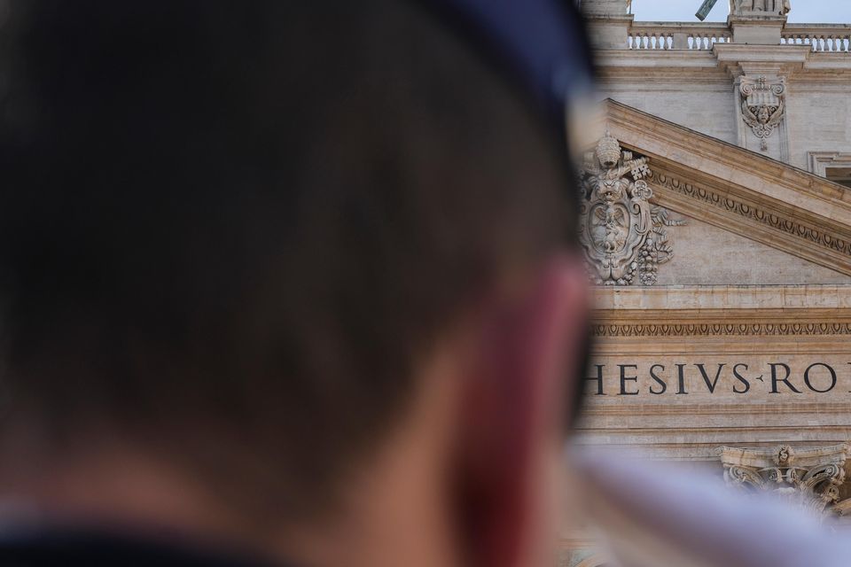 A Vatican gendarmerie officer salutes as Pope Francis prepares to deliver the Urbi et Orbi Christmas Day blessing from the main balcony of St Peter’s Basilica (Andrew Medichini/AP)