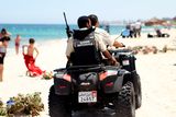 thumbnail: Tunisian security forces patrol a beach in Sousse, south of the capital Tunis, on July 1, 2015, as Tunisia started deploying armed police around tourist sites following last week's massacre in Port El Kantaoui by a jihadists gunman. Tunisian authorities vowed new heightened security measures, including 1,000 armed officers to reinforce tourism police -- who will be armed for the first time -- at hotels, beaches and other attractions. AFP PHOTO / BECHIR TAIEBBECHIR TAIEB/AFP/Getty Images