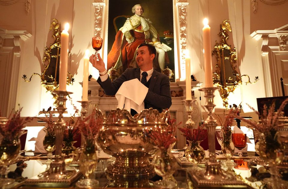 Final checks are made on the glassware as the stage is set for the dinner (Andrew Milligan/PA)