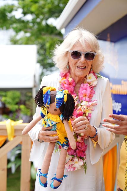 Camilla holds a gift presented to her during a visit to the Samoa Victim Support Group (Aaron Chown/PA)