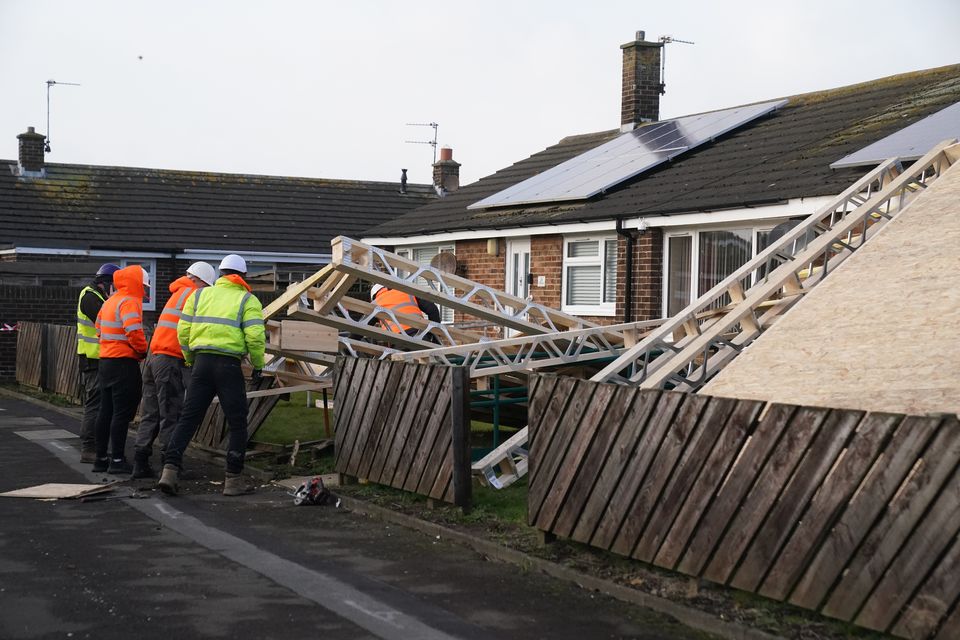 A roof blown off during strong winds rests on some bungalows in Amble, Northumberland, in the North East (Owen Humphries/PA)