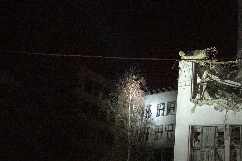 Firefighters inspect a damaged office building after it was hit by Russian aerial guided bombs in central Kharkiv (AP Photo/Efrem Lukatsky)