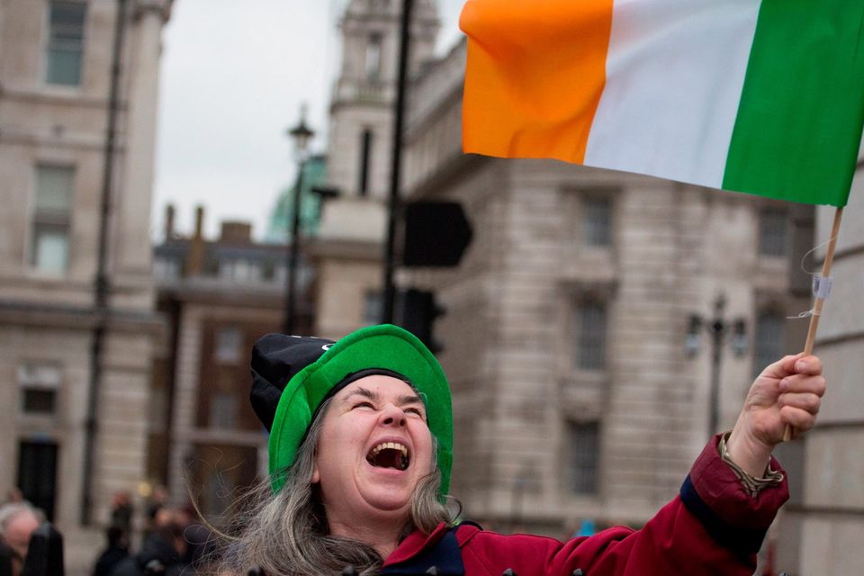 A woman waves an Irish flag at the Mayor of London's St Patrick's Day Parade and Festival in London. Daniel Leal-Olivas/PA Wire.