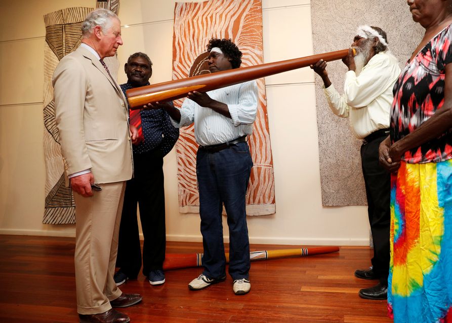 The Prince of Wales takes part in a didgeridoo demonstration during a visit to the Buku-Larrnggay Mulka Centre in Yirrkala in Australia’s Northern Territory in 2018 (Phil Noble/PA)