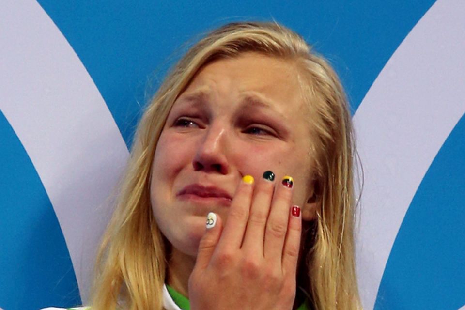 Ruta Meilutyte of Lithuania reacts as she receives her gold medal during the medal ceremony for the Women's 100m Breaststroke