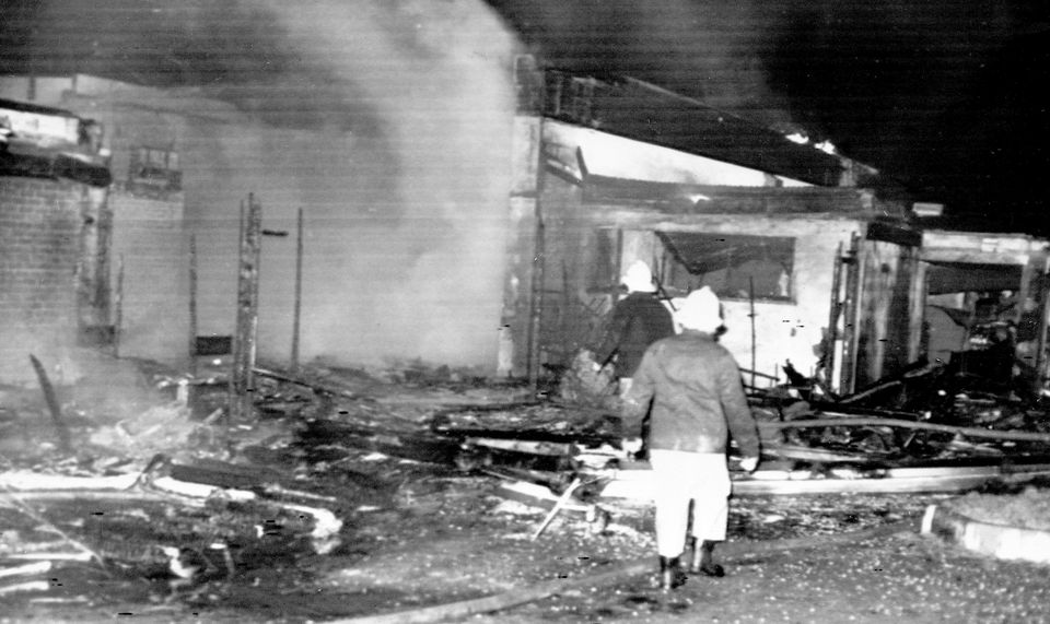 Firemen searching through the rubble at the wrecked La Mon House restaurant near Belfast (PA Archive)