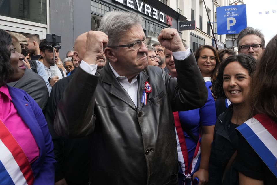 France Unbowed leader Jean-Luc Melenchon, centre, joins a protest in Paris on Saturday (Michel Euler/AP)