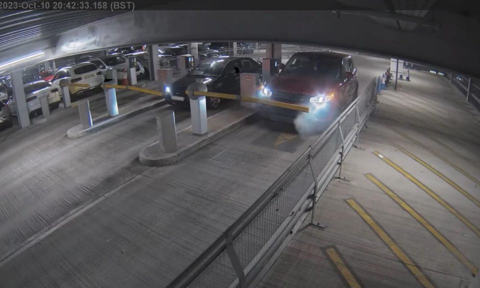 The Red Range Rover Sport arriving at the ticket barrier, with light smoke coming from the vehicle (Bedfordshire Fire and Rescue/PA)