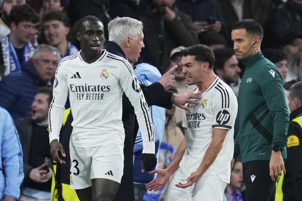 Brahim Diaz, right, celebrates with Carlo Ancelotti after scoring what proved to be the winner against rivals Atletico (Manu Fernandez/AP)