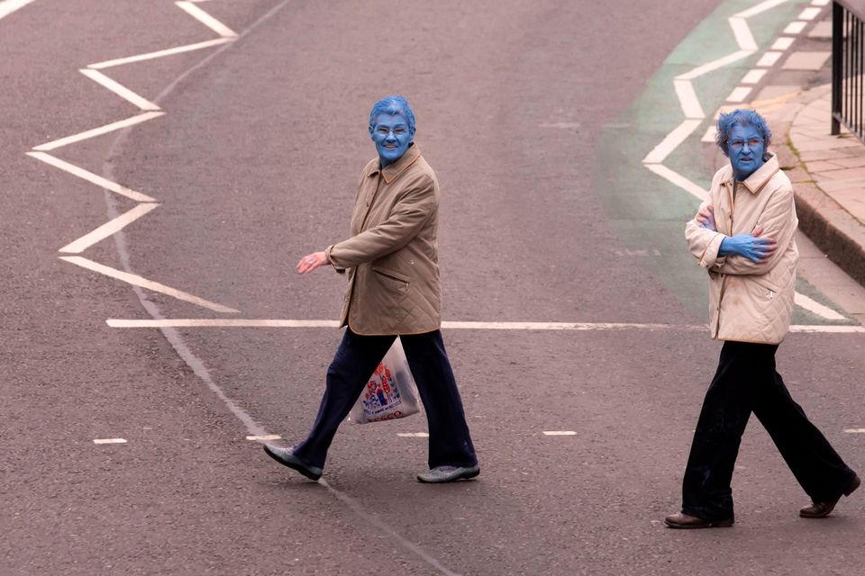 After taking part in Spencer Tunick's "Sea of Hull" installation, two women cross the road in Kingston upon Hull on July 9, 2016. AFP/Getty Images