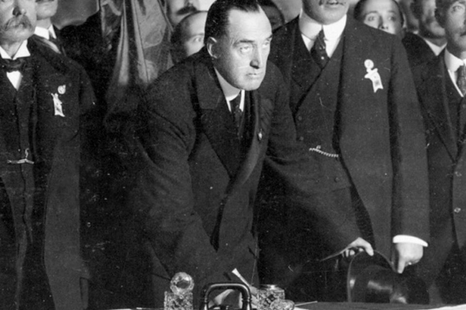 Sir Edward Carson puts the first signature on the Ulster Covenant at Belfast City Hall in 1912