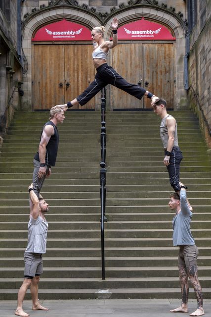 Acrobats take part in a display in front of the Assembly Hall in Edinburgh during a photocall for the Gravity and Other Myths show Ten Thousand Hours, ahead of their appearance at the Edinburgh Fringe Festival in August (Jane Barlow/PA)