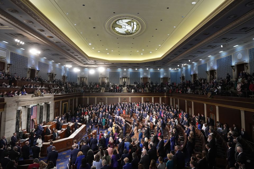 Members bow their heads during the opening prayer as the House of Representatives meets to elect a speaker and convene the new 119th Congress at the Capitol in Washington (Mark Schiefelbein/AP)