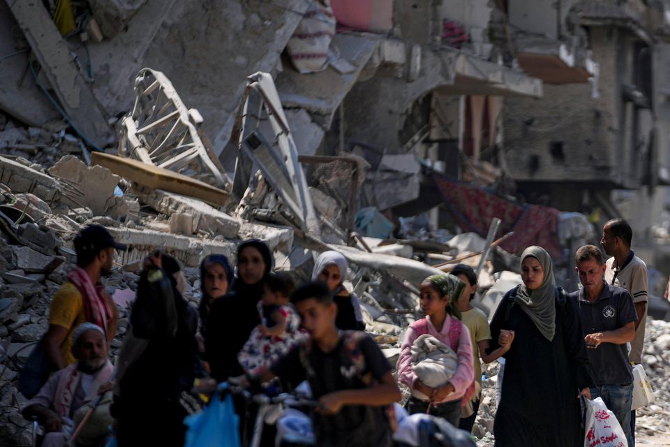 Palestinians displaced by the Israeli air and ground offensive on the Gaza Strip flee from parts of Khan Younis (Abdel Kareem Hana/AP)