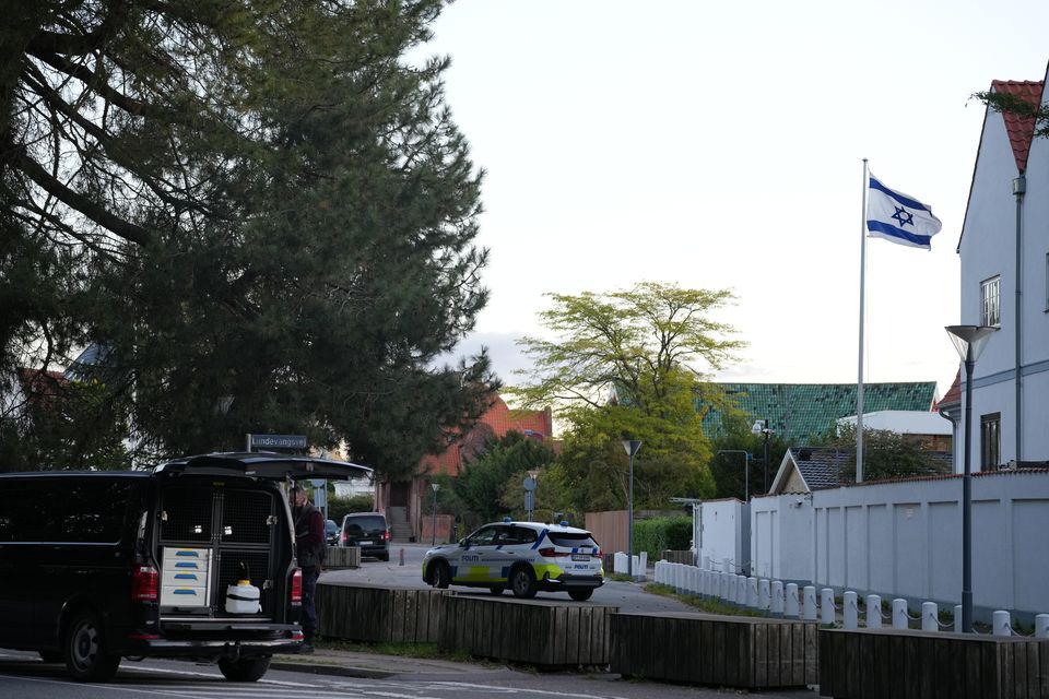 A police vehicle is seen near the Israeli embassy in Copenhagen, as police investigate two explosions near the site (Emil Helms/Ritzau Scanpix via AP)