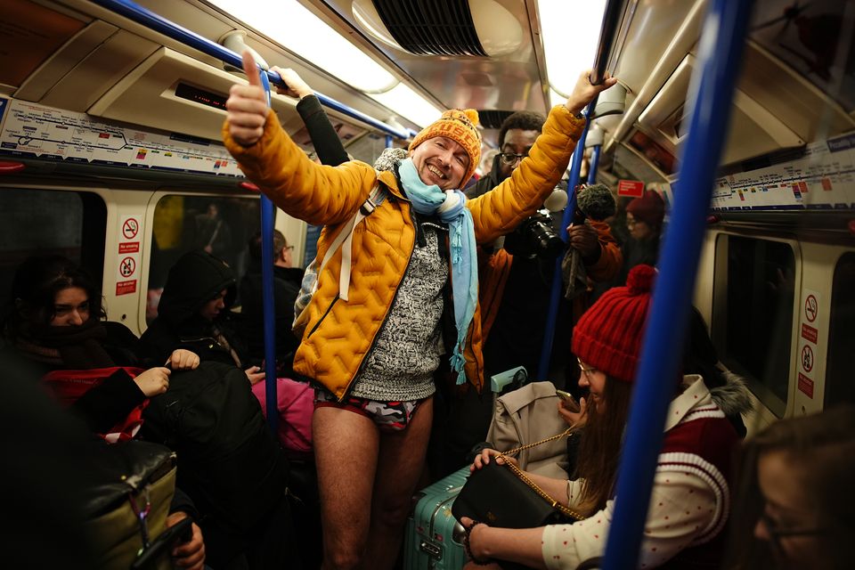 One man opted for a more cosy look with an orange puffer jacket, orange beanie and blue scarf (Aaron Chown/PA)