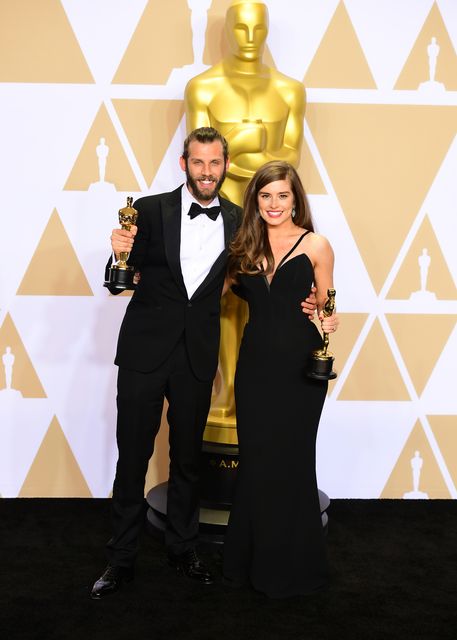 Chris Overton and Rachel Shenton with their best live action short film Oscar for The Silent Child (Ian West/PA)