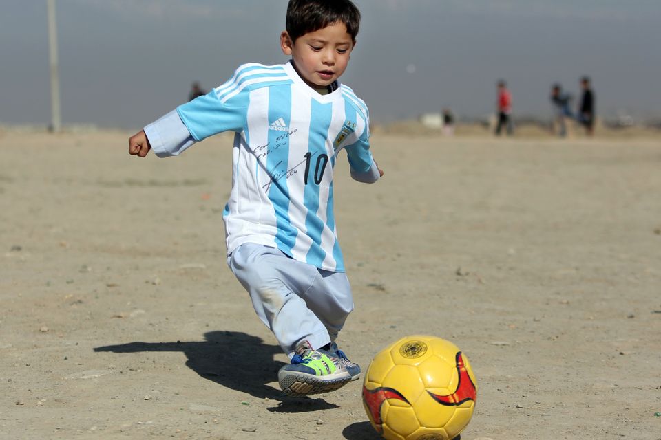 Five-year-old Murtaza Ahmadi pictured wearing homemade 'Messi 10