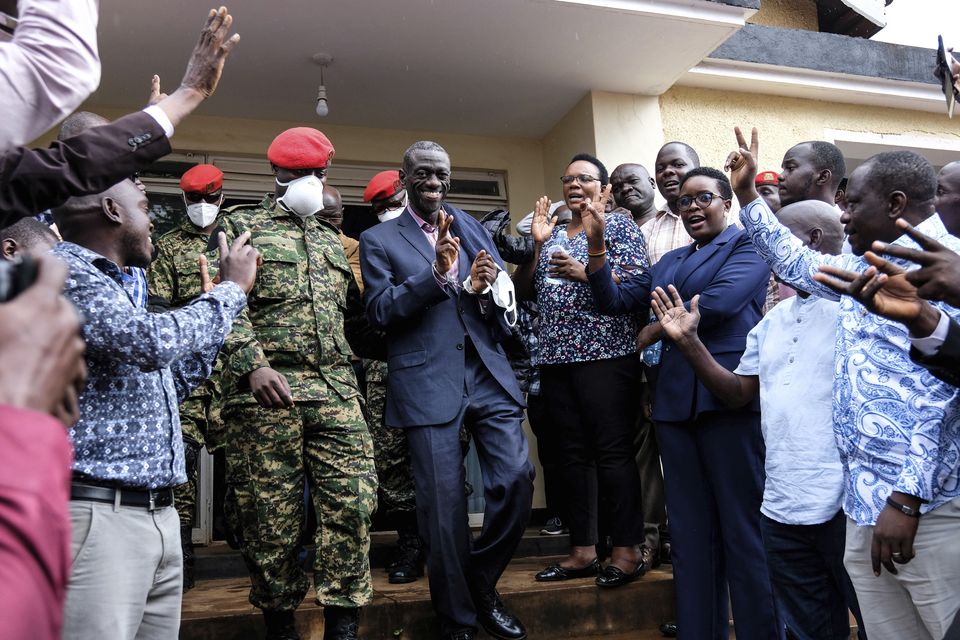 Ugandan opposition leader and four-time presidential candidate Kizza Besigye, centre left, arrives at the Makindye Martial Court in Kampala in November 2024 (Hajarah Nalwadda/AP)