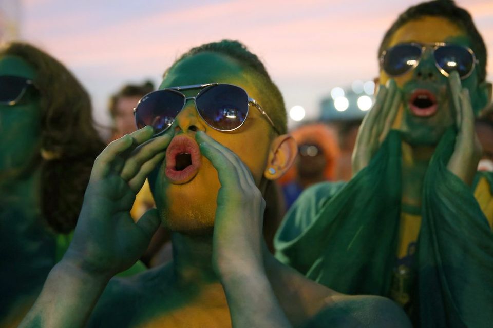 RIO DE JANEIRO, BRAZIL - JUNE 23:  Brazilian soccer fans watch their team play against Cameroon while watching on a screen at the FIFA Fan Fest on Copacabana beach June 23, 2014 in Rio de Janeiro, Brazil.  (Photo by Joe Raedle/Getty Images)