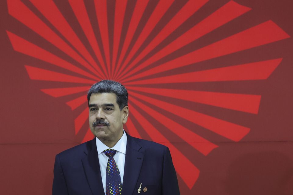 Venezuelan President Nicolas Maduro waits to receive attendees at the start of the Bolivarian Alliance for the Peoples of Our America (Alba) Summit in Caracas (Jesus Vargas/AP)