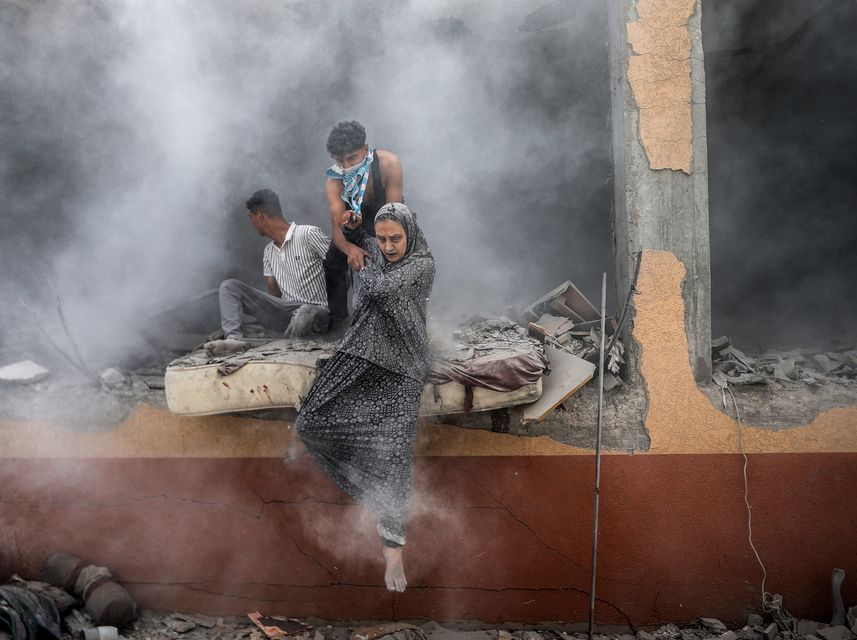 DEIR AL BALAH, GAZA - JUNE 14: Palestinians walk out of the rubble, covered in dust after the Israeli attack on Abu Aisha family house in Deir al Balah, Gaza on June 14, 2024. (Photo by Ali Jadallah/Anadolu via Getty Images)