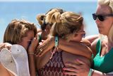thumbnail: A British family, who witnessed the beach massacre by a jihadists gunman the previous week, mourn as they lay flowers at the site of the attack on the beach in front of the Riu Imperial Marhaba Hotel in Port el Kantaoui, on the outskirts of Sousse south of the capital Tunis, on June 30, 2015. Tunisia's President Beji Caid Essebsi has admitted security services were not prepared for the beach attack, as authorities warned the country is likely to lose more than half-a-billion dollars in tourism revenues. AFP PHOTO / KENZO TRIBOUILLARDKENZO TRIBOUILLARD/AFP/Getty Images