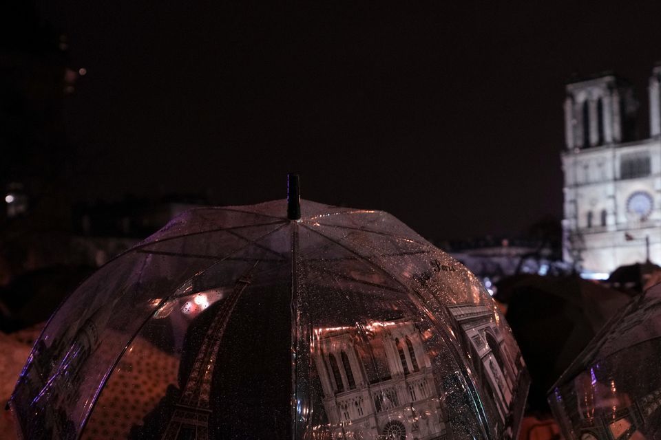 Spectators gather outside Notre Dame Cathedral on Saturday (Alessandra Tarantino/AP)