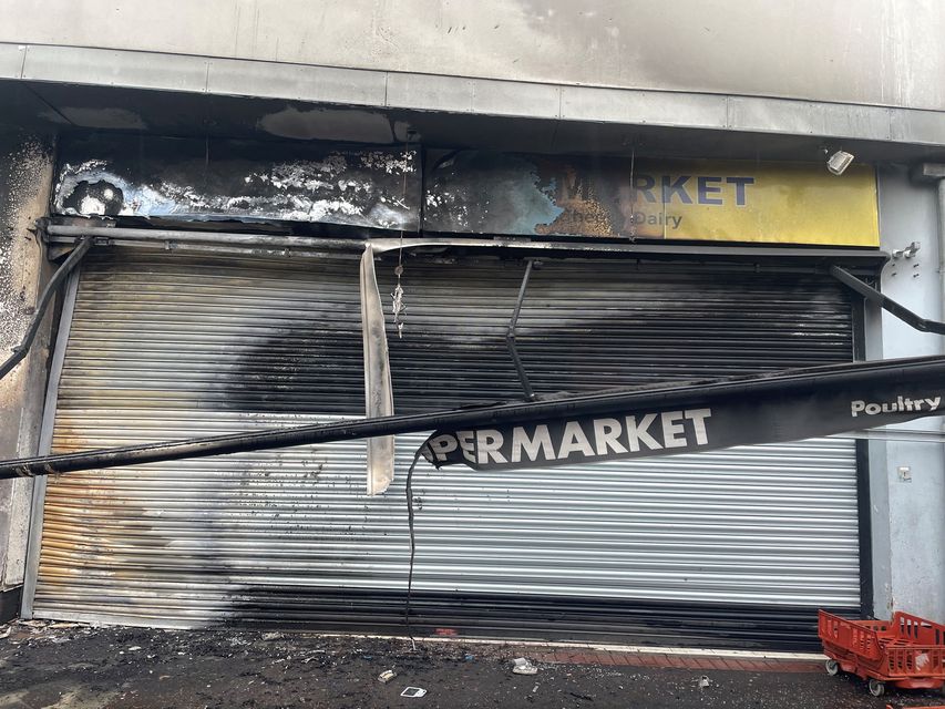 The supermarket badly damaged by fire in the Donegall Road in south Belfast following disorder after anti-immigration protests (Jonathan McCambridge/PA)