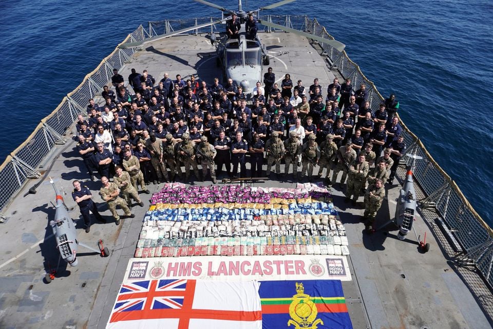 The crew of HMS Lancaster after they seized heroin and methamphetamines from drug smugglers (Lt Nathan Boal/PA)