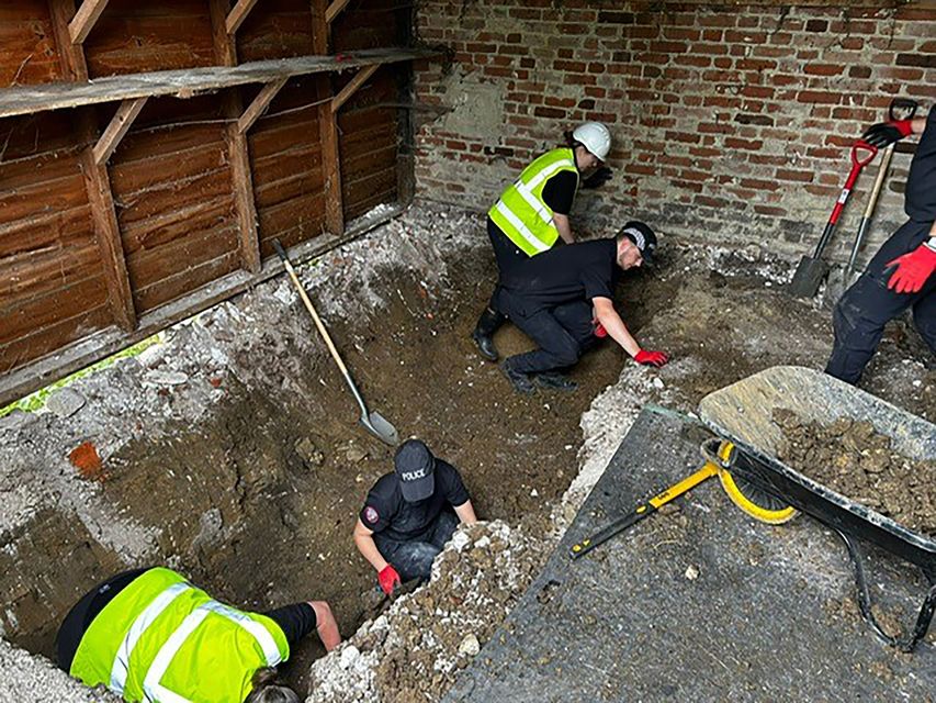 Police searching inside a barn at the farm last week. (Metropolitan Police/PA)