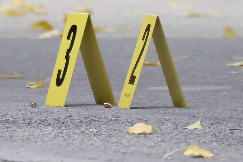 Bullets lie on the sidewalk at the scene outside the Hilton Hotel in midtown Manhattan where Mr Thompson was fatally shot (Stefan Jeremiah/AP)