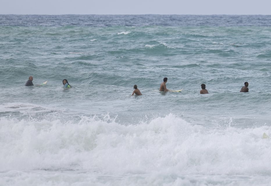 Surfers wait for a wave before the passage of Tropical Storm Ernesto at La Pared beach in Luquillo, Puerto Rico (Alejandro Granadillo/AP/PA)