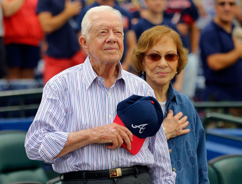 Former President Jimmy Carter and his wife, Rosalynn, stand for the national anthem before a baseball game between the Atlanta Braves and the San Diego Padres, June 10, 2015, in Atlanta (AP Photo/John Bazemore, file)