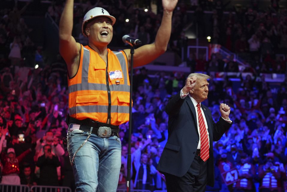 Mr Trump danced on stage with The Village People at a rally ahead of the 60th Presidential Inauguration (AP)