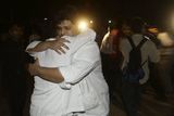 thumbnail: Employees of the Taj Hotel comfort each other after they were rescued from the hotel in Mumbai, India, Thursday, Nov. 27, 2008. Teams of heavily armed gunmen have stormed luxury hotels and other sites in coordinated attacks across India's financial capital, killing at least 82 people and taking Westerners hostage. (AP Photo/Gautam Singh)