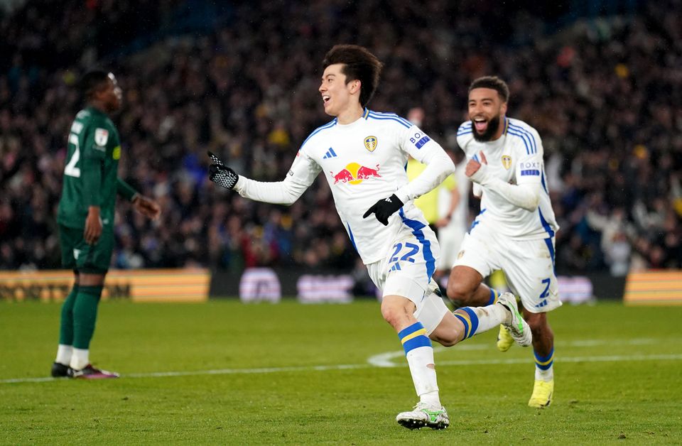 Ao Tanaka (left) celebrates his goal as Leeds beat Millwall to return to the top of the Championship (Owen Humphreys/PA)