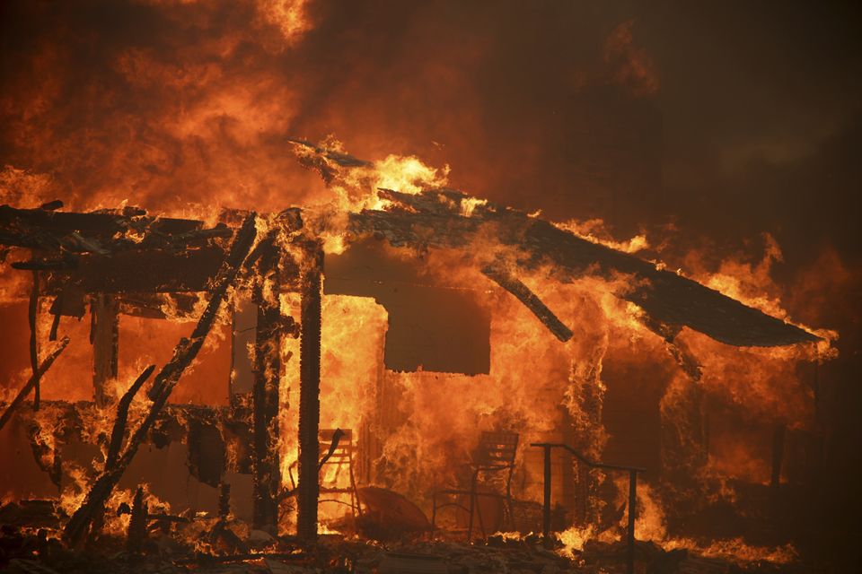 Flames engulf a structure during the Mountain Fire (Ethan Swope/AP)