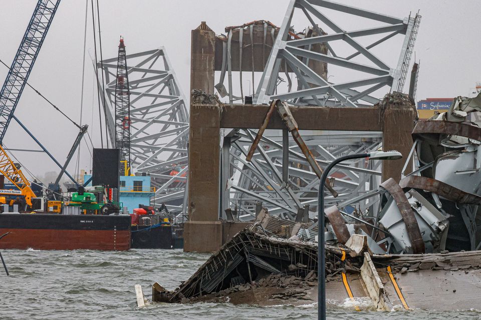 Cranes continue salvage work as the wreckage of the Francis Scott Key Bridge rests on the container ship Dali (Julia Nikhinson/AP)