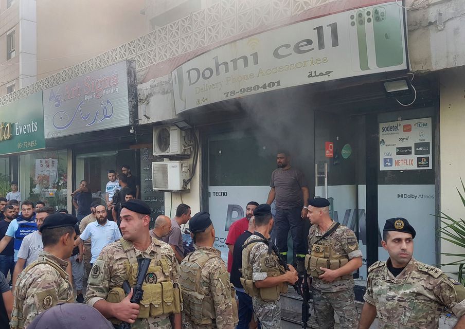 Lebanese soldiers gather outside a damaged mobile shop after what is believed to be the result of a walkie-talkie exploding inside it, in the southern port city of Sidon, Lebanon, Wednesday, Sept. 18, 2024 (AP Photo/Mohammed Zaatari)