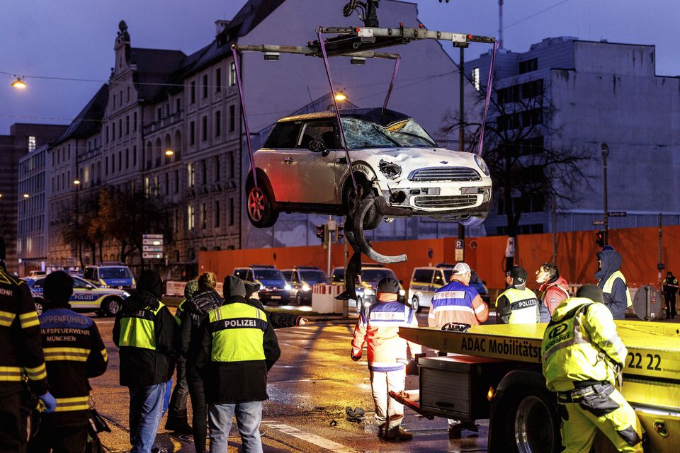 A car is lifted on to a lorry at the scene of the attack (Matthias Balk/dpa/AP)