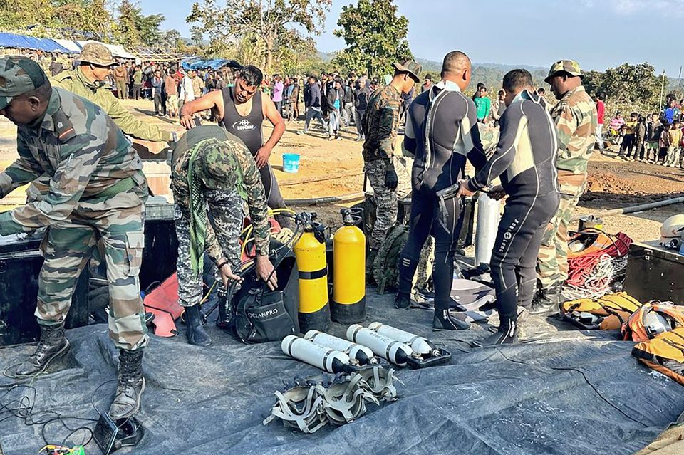 Soldiers preparing their equipment to rescue workers trapped inside a coal mine in Umrangso, India (Indian Army/AP)