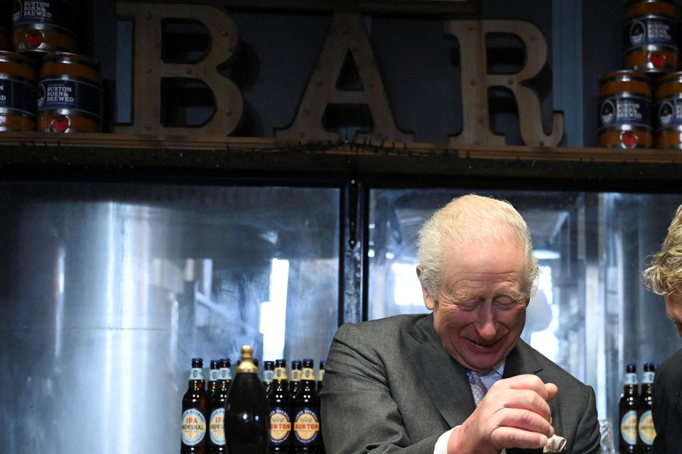 The King pulls a pint with Tower Brewery owner John Mills (Jaimi Joy/PA)