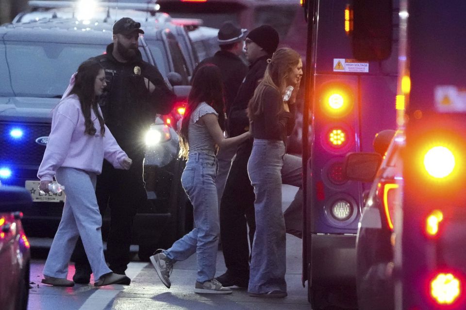 Students board a bus as they leave a shelter (Morry Gash/AP)