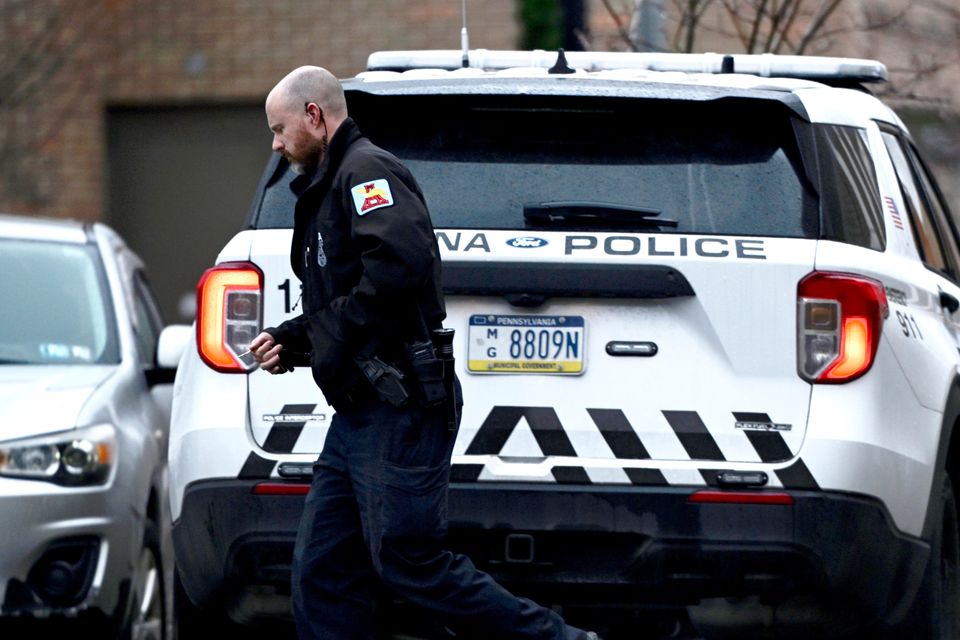 A law enforcement officer walks into the Altoona Police Department (Benjamin B Braun/Pittsburgh Post-Gazette via AP)