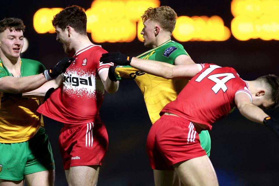 Derry and Donegal players clash during the 2024 McKenna Cup Final